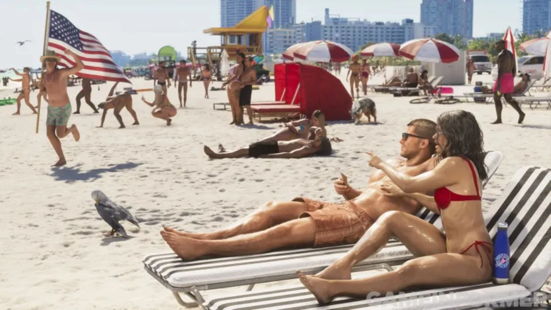 A packed beach of sunbathers under red and white umbrellas, with a man running with a US flag, a couple lying on loungers in the foreground, a bird on the sand and tall buildings behind