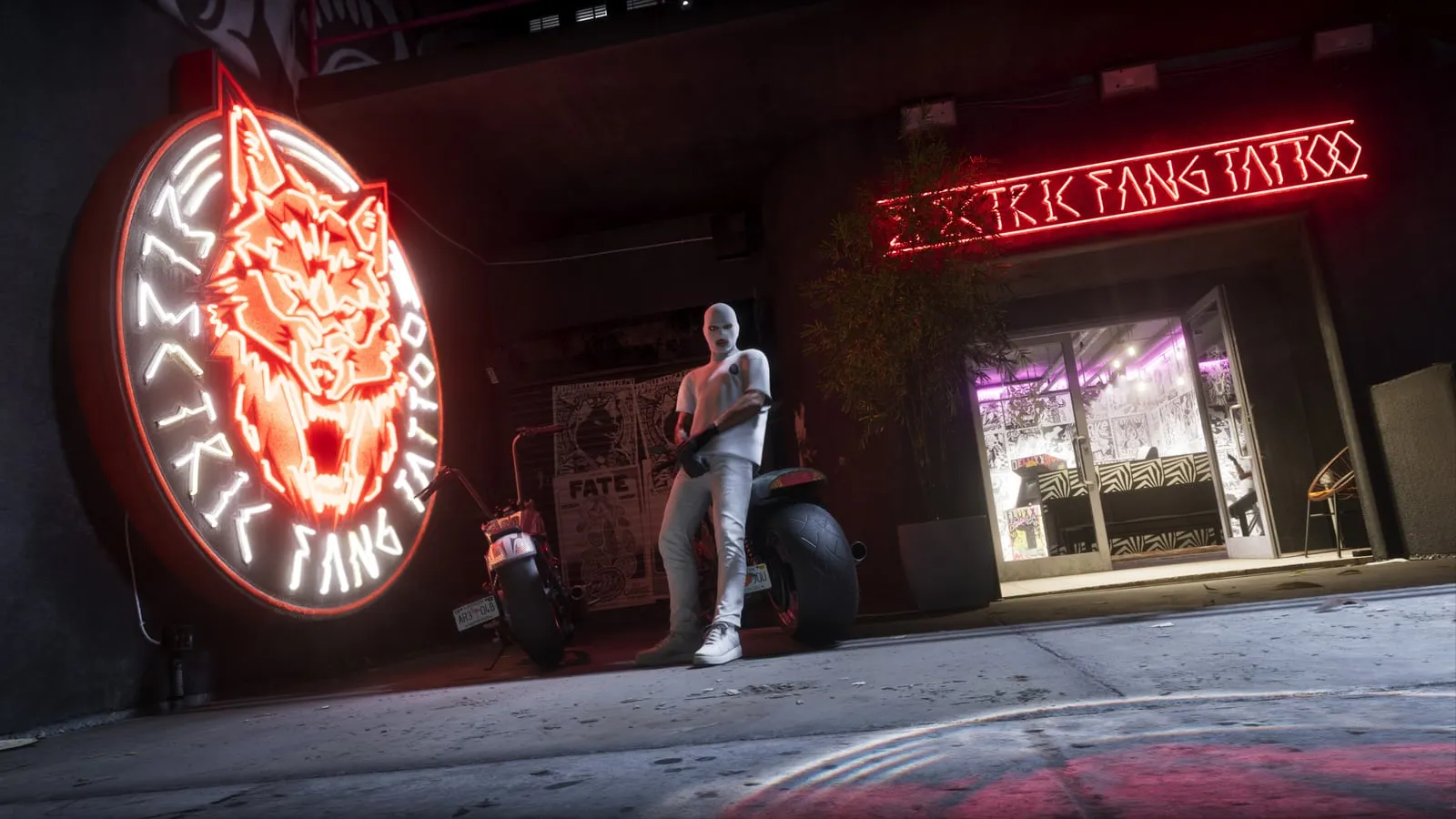 The neon Electric Fang Tattoo sign, with a wolf's head, reflected on the tarmac at night