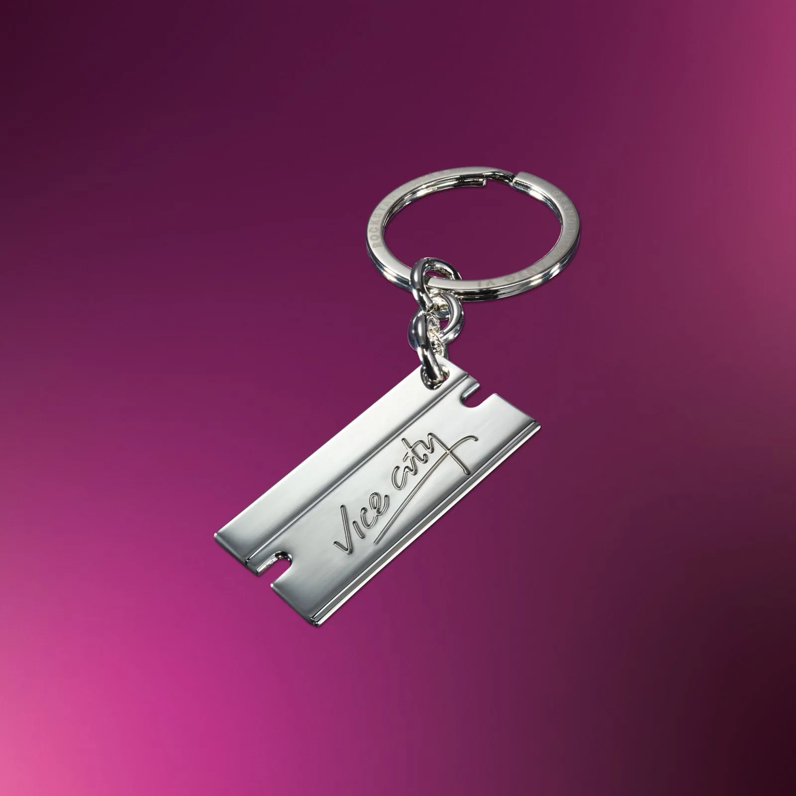 A silver keychain shaped like a razor blade, engraved with the Vice City lettering
