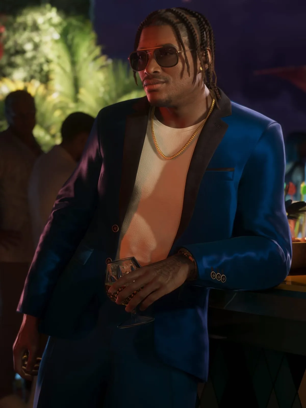 Dre'Quan Priest in a blue blazer beside a pool at night