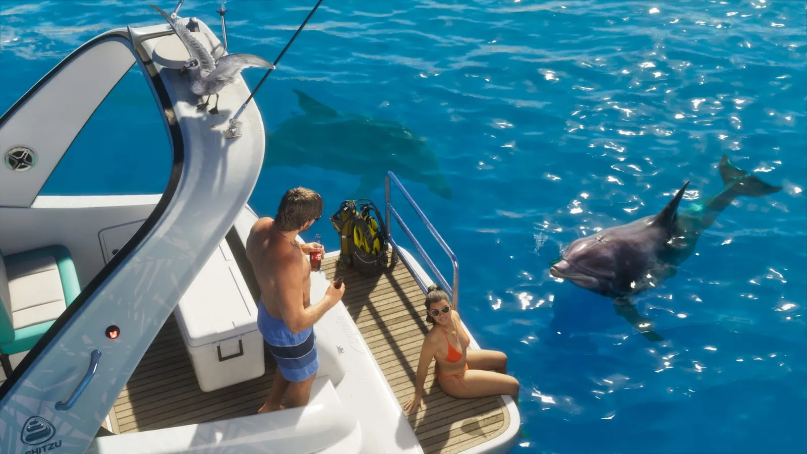 Jason and Lucia on the deck of a Squalo speedboat in open water, with a dolphin swimming alongside